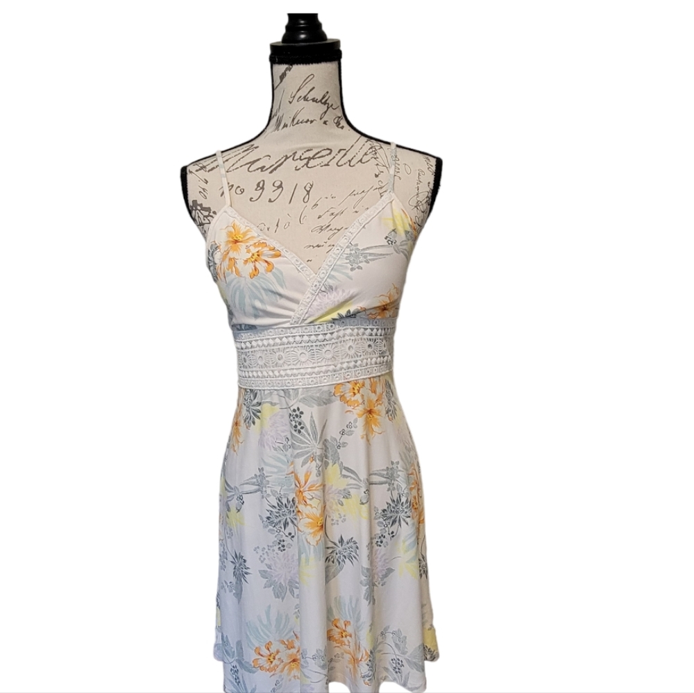 This is a Hawaiian floral 🌺 sun dress with a triangle top and lace accents.